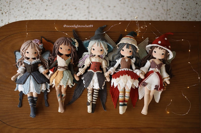 Five crochet fairy dolls in different colored dresses